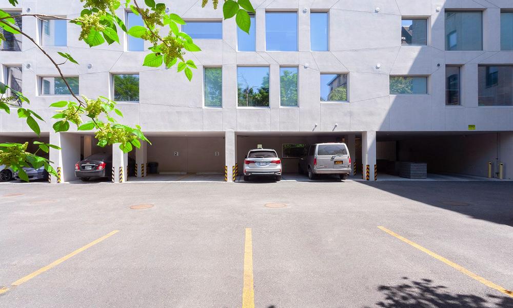 Parking garage on property with view of secure access gate