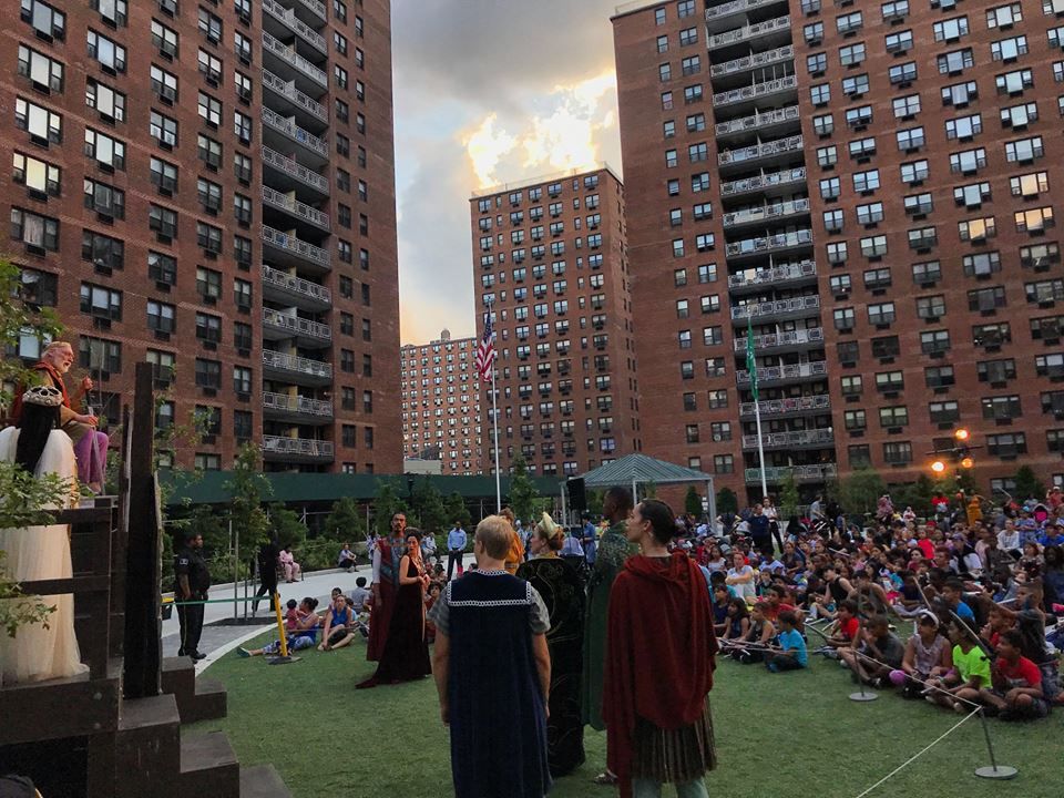 People gathered at the Center Courtyard, LeFrak City apartments watching Shakespeare in the Park