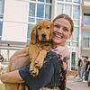 smiling woman holding puppy