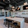 Community kitchen with bar seating and TVs