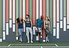 A group of residents standing and laughing together in front of a vibrant, colorful mural, enjoying a casual moment of connection and relaxation