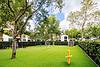 A well-maintained dog park featuring agility equipment, green grass, and trees. Ideal for pets to play and exercise.