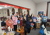 Group of people holding art and waving