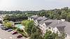 Aerial view of Carlton Oaks with parking lot and trees in its surrounding