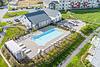 Drone view of pool, grilling area, and clubhouse