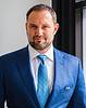 man with short hair and beard wearing suit and tie