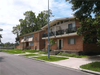 exterior of two story brick building showing the street, sidewalk, and driveway