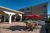 Grills and tables with chairs on patio