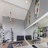 a room with weight equipment and a large mirror