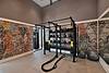 a room with a brick wall and weight equipment and bounce balls