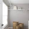 Walk in closet with wire shelves and woven baskets and white dresser