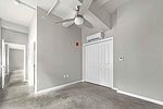 a room with white doors and a ceiling fan