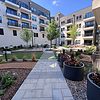 Park Courtyard with seating, grilling stations and greenery.