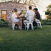 a group of people sitting at a table outside