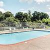 a swimming pool with chairs around it