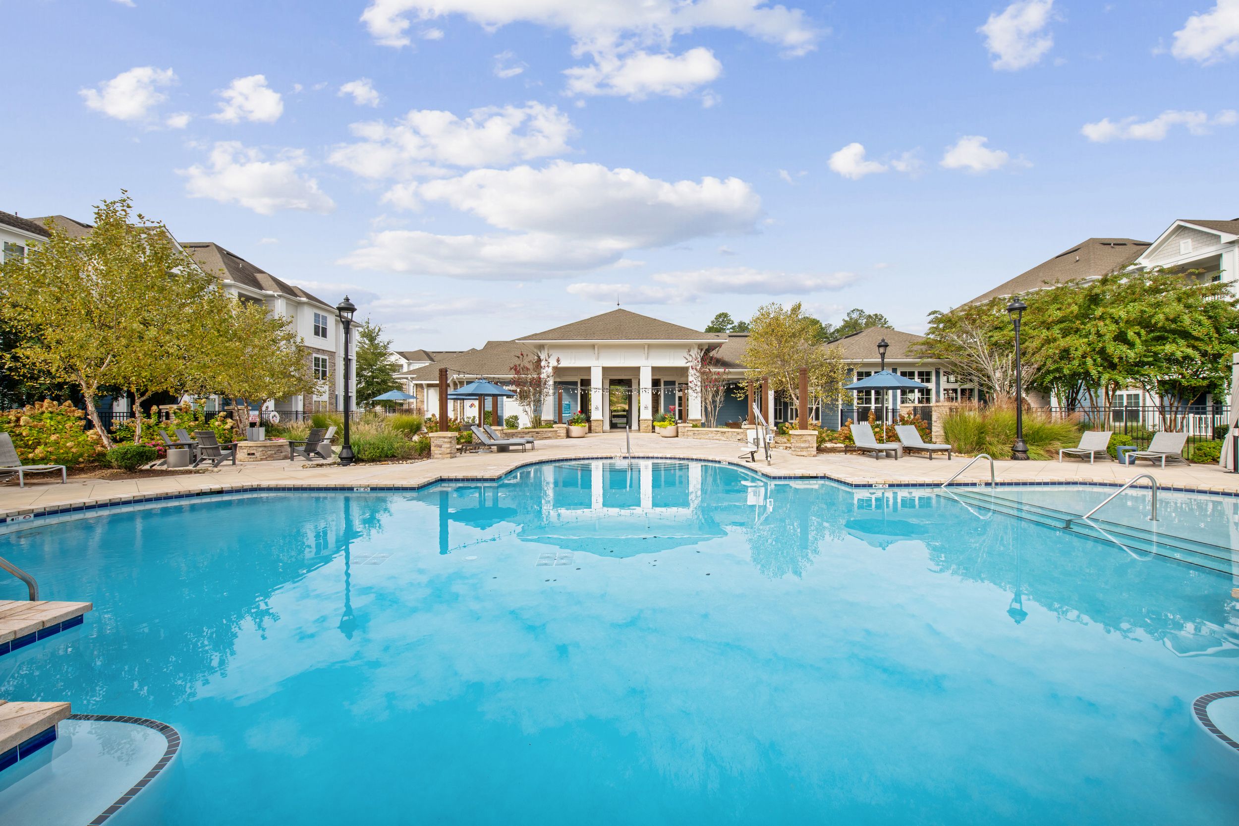 Resort-Style Saltwater Pool Area with Sun Shelf at Patterson Place Apartments.