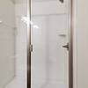 Walk-in, glass door shower at Realm at Patterson Place.