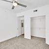 bedroom with ample room for furniture, large closet, carpet, and ceiling fan