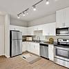 Apartment Kitchen with granite countertops and stainless steel appliances at Lantower Edgewater