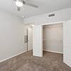 Carpet bedroom with a spacious closet, and a ceiling fan at Lantower Edgewater