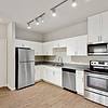 Kitchen with granite countertops and stainless steel appliances at Lantower Edgewater
