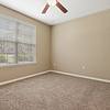 Carpeted bedroom with a ceiling fan and large window