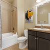 Large bathroom with a deep soaking tub and a well-lit vanity at Lantower Cypress Creek.