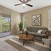 Spacious, carpeted living room with two large windows for ample natural light, and a door leading to a private balcony at Lantower Cypress Creek.