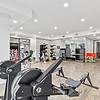 24-Hour Fitness Center with Yoga Room & Fitness On-Demand with wooden floors gym equipment at Lantower Grande Flats Apartments.