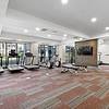 24-Hour Fitness Center with floor-to-ceiling windows at Lantower Grande Flats Apartments.