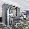 Fully equipped fitness center with free weights, cardio machines, and display monitors at Lantower Waverly Apartments.
