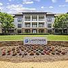 The entrance of Lantower Waverly with a lush, green lawn and neatly landscaped flower beds.