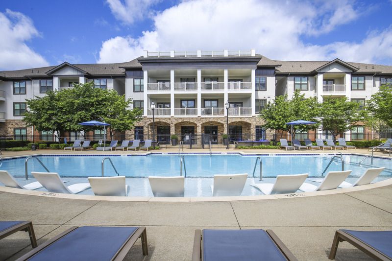 Large, resort-style pool with poolside cabanas, lounge seating, and a tanning ledge at Lantower Waverly.