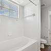 Bathroom with large garden tub with window for natural light at Residences at the Collection.