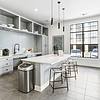 kitchen with stainless steel appliances and an island with overhead lighting and stools at Lantower Residences at the Collection