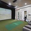 Virtual, PGA-Quality Golf Simulator with artificial grass and a viewing area at Lantower Asturia Apartments.