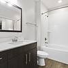 Bathroom with brushed nickel fixtures, wood plank floors, and soaking tub at Lantower Brandon Crossroads.