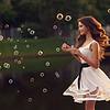 woman blowing bubbles outdoors