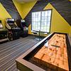 Game room with arcade games and shuffleboard