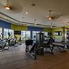 fitness studio with ceiling fans and cardio machines