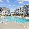Large, resort-style pool with poolside cabanas, lounge seating, and a tanning ledge at Lantower Garrison Park.