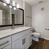 Bathroom with storage, a shower/tub combo, and large countertops. 