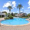 Sparkling swimming pool with plenty of seating at Tortuga Bay at Waterford Lakes.