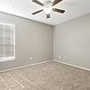 bedroom with ceiling fan, large window for natural lighting, and carpet flooring at Lantower Round Rock.