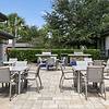 A sunny, outdoor seating area with two stainless steel grills at Lantower Grande Pines.