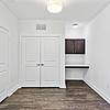 Room with office space, dark wood-stained cabinets, vinyl plank flooring and closet access at Lantower Techridge apartments