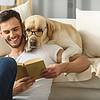 Man reading with dog on shoulder