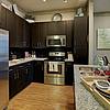 Kitchen with wood flooring and stainless steel and black appliances