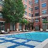 swimming pool area with seating and shade