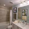 View of bathroom with white cabinetry and shower tub combination